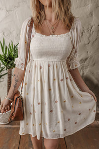 Beige Embroidered Flower Smocked Bust Half Puff Sleeve Empire Waist Textured Flowy Dress | Arrow Boutique | | Arrow Women's Boutique