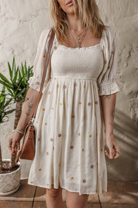 Beige Embroidered Flower Smocked Bust Half Puff Sleeve Empire Waist Textured Flowy Dress | Arrow Boutique | | Arrow Women's Boutique